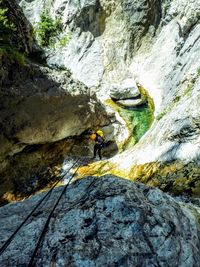 Rear view of person standing on rock