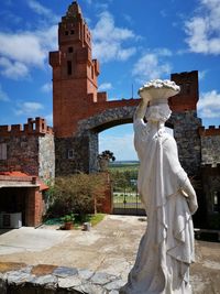 Statue of historic building against sky