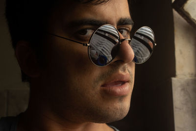 Close-up portrait of young man wearing sunglasses