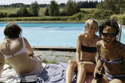 Happy women at swimming-pool