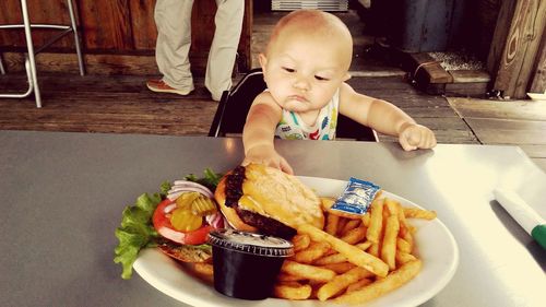 Boy eating food in plate