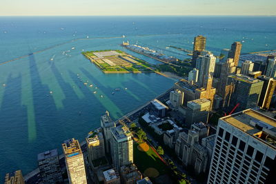 High angle view of buildings by sea against sky