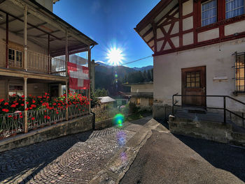 Street by buildings against sky in city