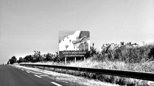 Road sign against trees