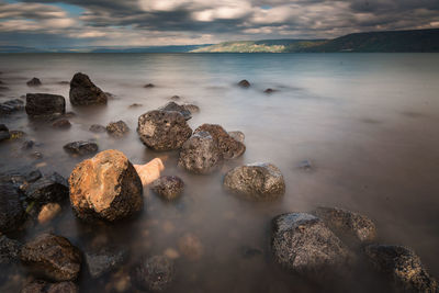 Rocks in sea against sky