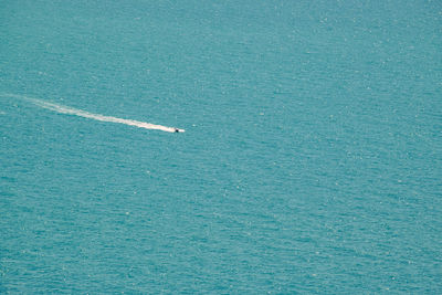 High angle view of airplane flying over sea