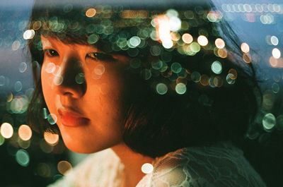 Close-up portrait of a young woman looking away