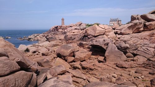 Rocky shore against sky