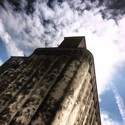 Low angle view of building against cloudy sky