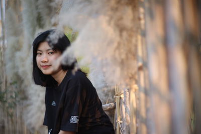 Portrait of a smiling young woman standing outdoors