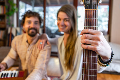 Portrait of couple holding musical instrument