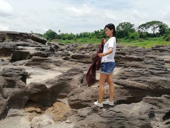 Full length of woman standing on rock