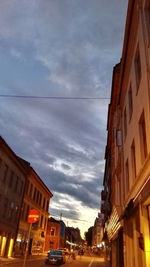 Low angle view of buildings against cloudy sky