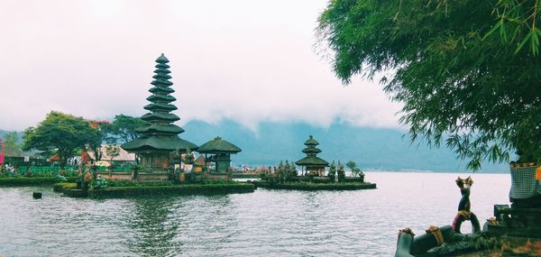 Scenic view of lake by building against sky