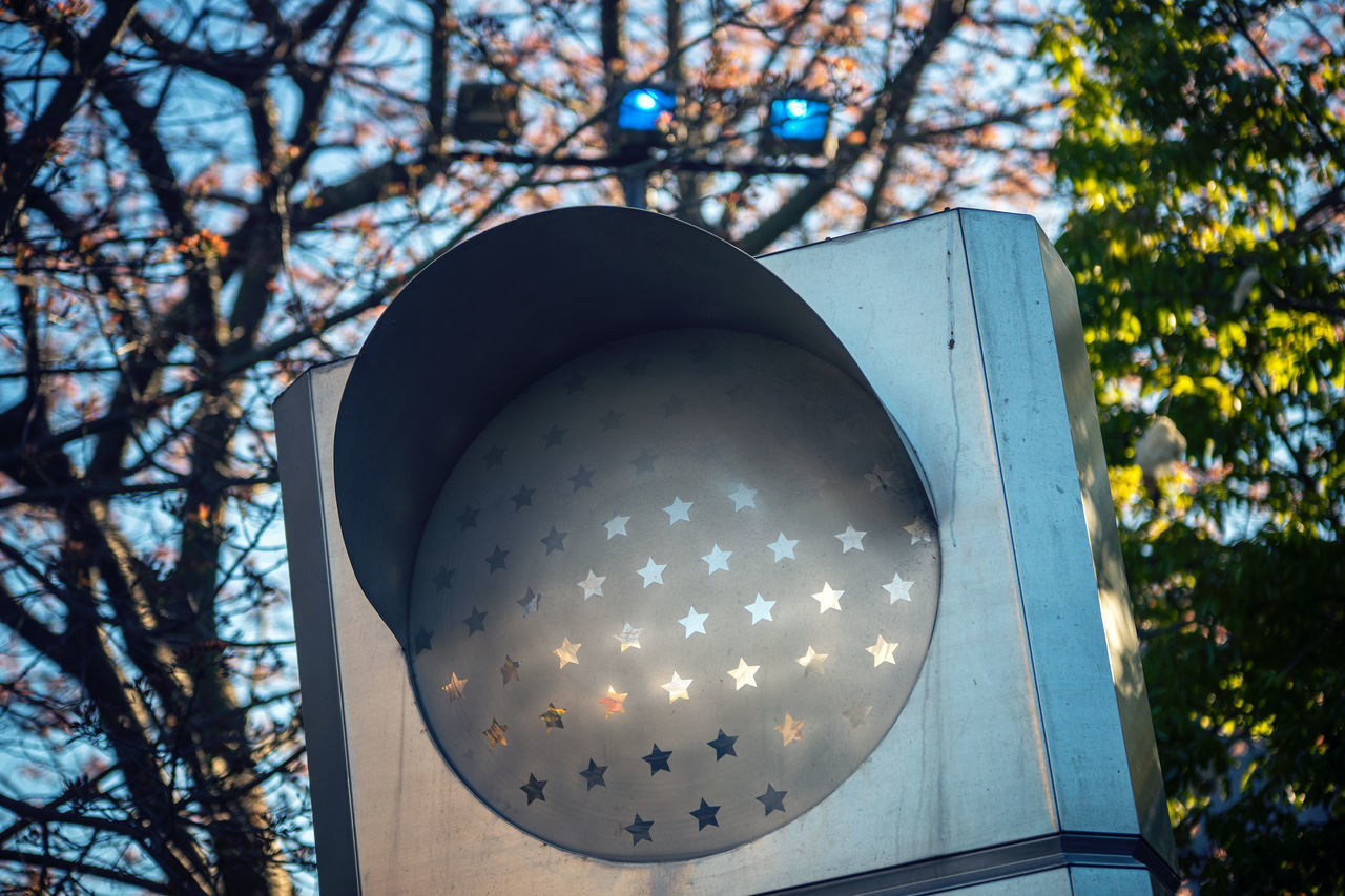 LOW ANGLE VIEW OF ILLUMINATED ELECTRIC LAMP ON TREE