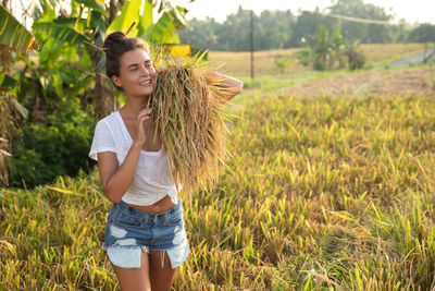 Young woman standing on field