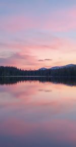 Scenic view of lake against romantic sky at sunset