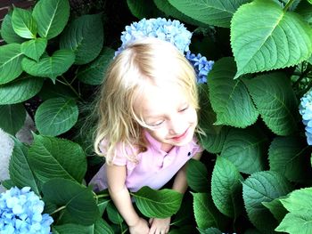 Woman looking away while holding plant