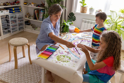 High angle view of mother and daughter on table