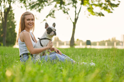 Young woman with dog on field