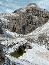 Scenic view to a pond infront of snowcapped sella mountain, dolomites, south tyrol, italy 