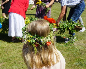 Rear view of girl wearing wreath at park during wedding