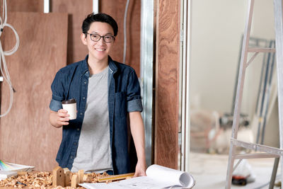 Portrait of a smiling young man holding food