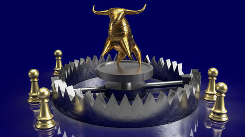 Close-up of buddha statue against blue background