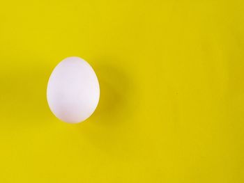 Directly above shot of balloons against yellow background