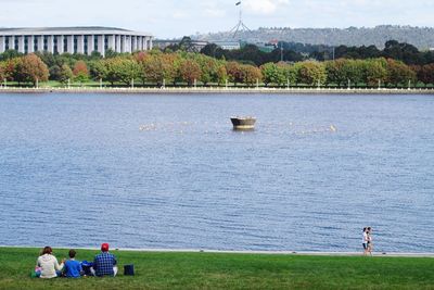 Man sitting on bench in lake
