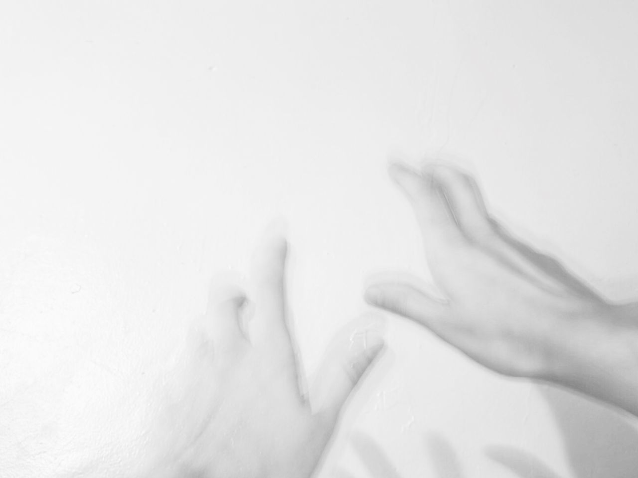 CLOSE-UP LOW SECTION OF WOMAN AGAINST WHITE BACKGROUND