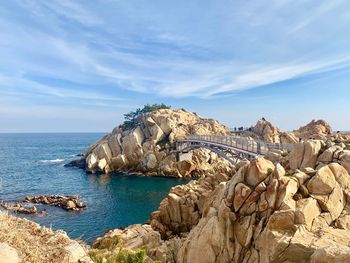 Scenic view of rocks in sea against sky