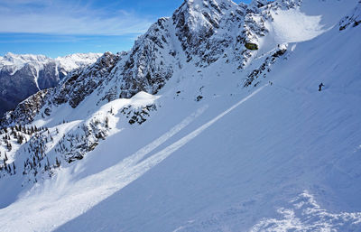 Scenic view of snow covered mountains against sky