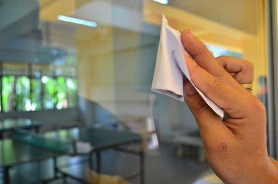 Close-up of hand holding paper