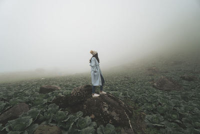 Full length of woman standing in farm