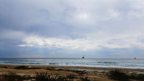 View of calm sea against cloudy sky