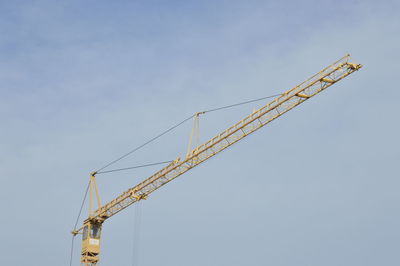 Cranes at construction site against sky
