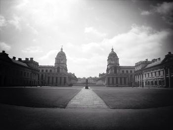 Buildings against cloudy sky
