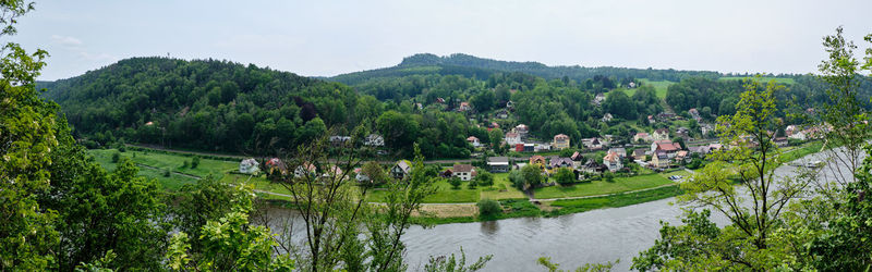 High angle view of river amidst trees against sky