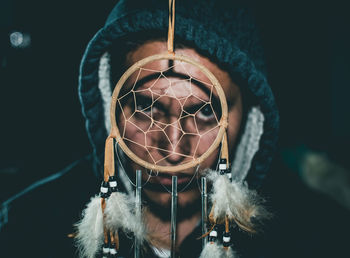 Close-up of man hanging against blurred background