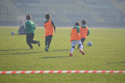 People playing soccer on field