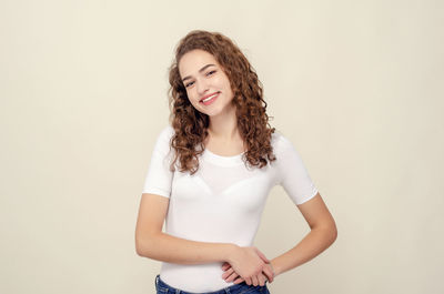 Portrait of smiling woman against white background
