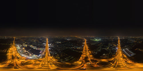 Aerial view of illuminated buildings in city at night