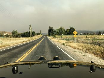 Cars on road against sky