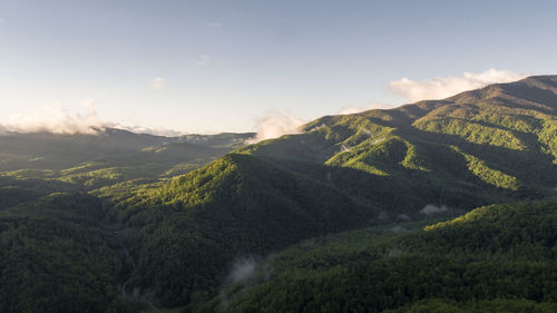 Scenic view of mountain against cloudy sky