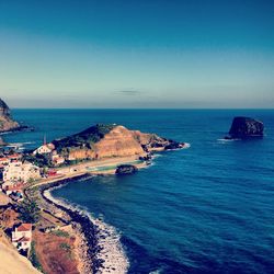 Scenic view of sea against clear blue sky