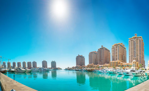 Buildings by swimming pool against sky