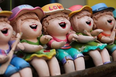 Close-up of wooden dolls on shelf