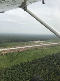 Scenic view of field against sky seen through airplane