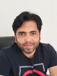 Portrait of young man against white background